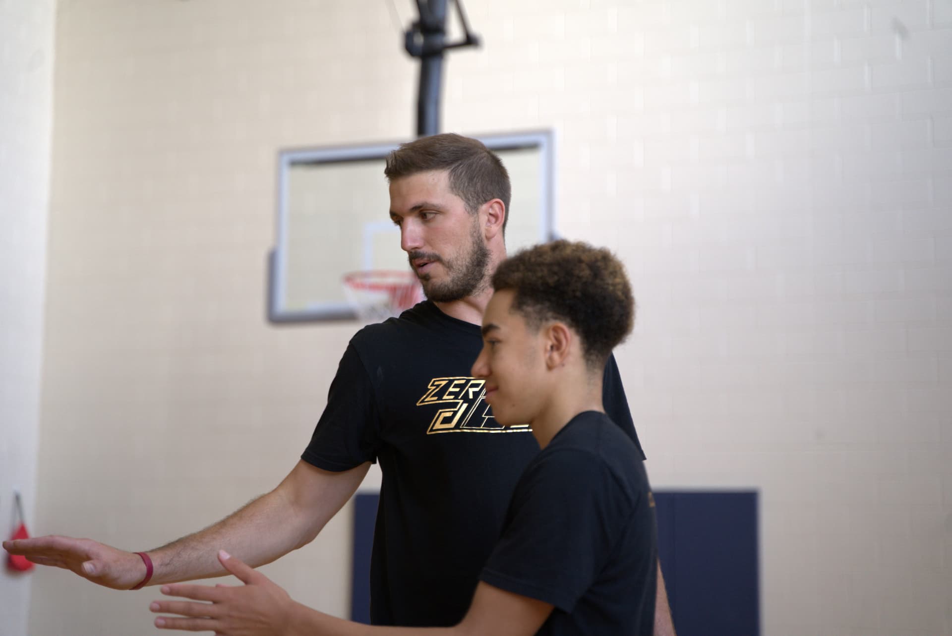 Marko coaching a player in the gym